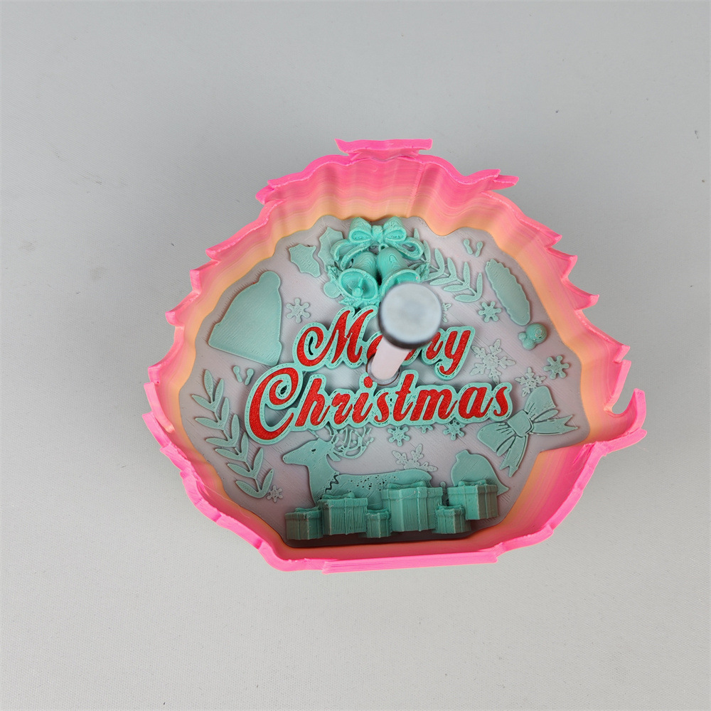 Close-up Christmas tree shadow lamp showing pink trim, Merry Christmas lettering, holiday bells, reindeer, snowflakes and presents