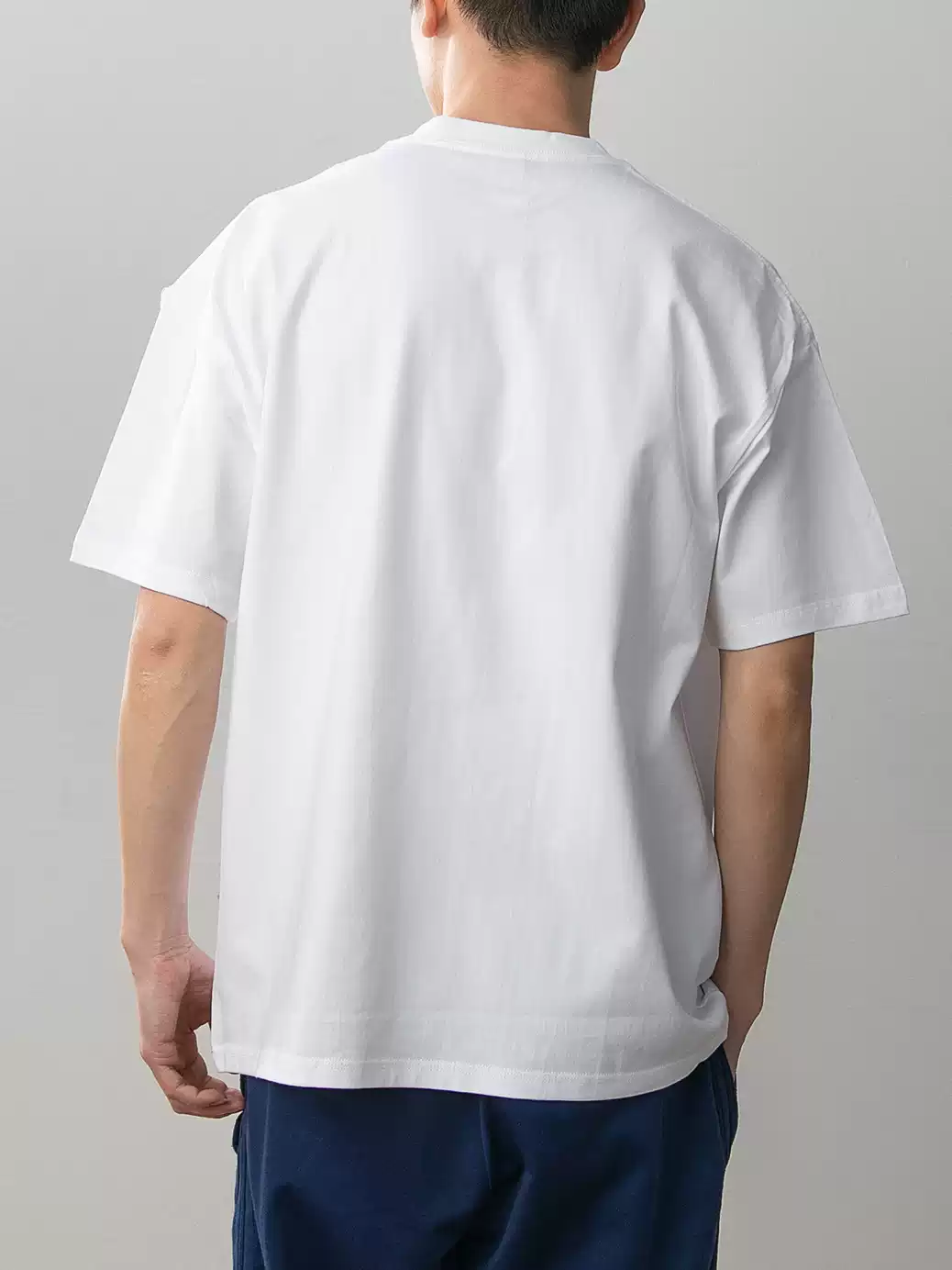 Rear view of plain white Demon Slayer Tanjiro and Nezuko T-shirt on a model