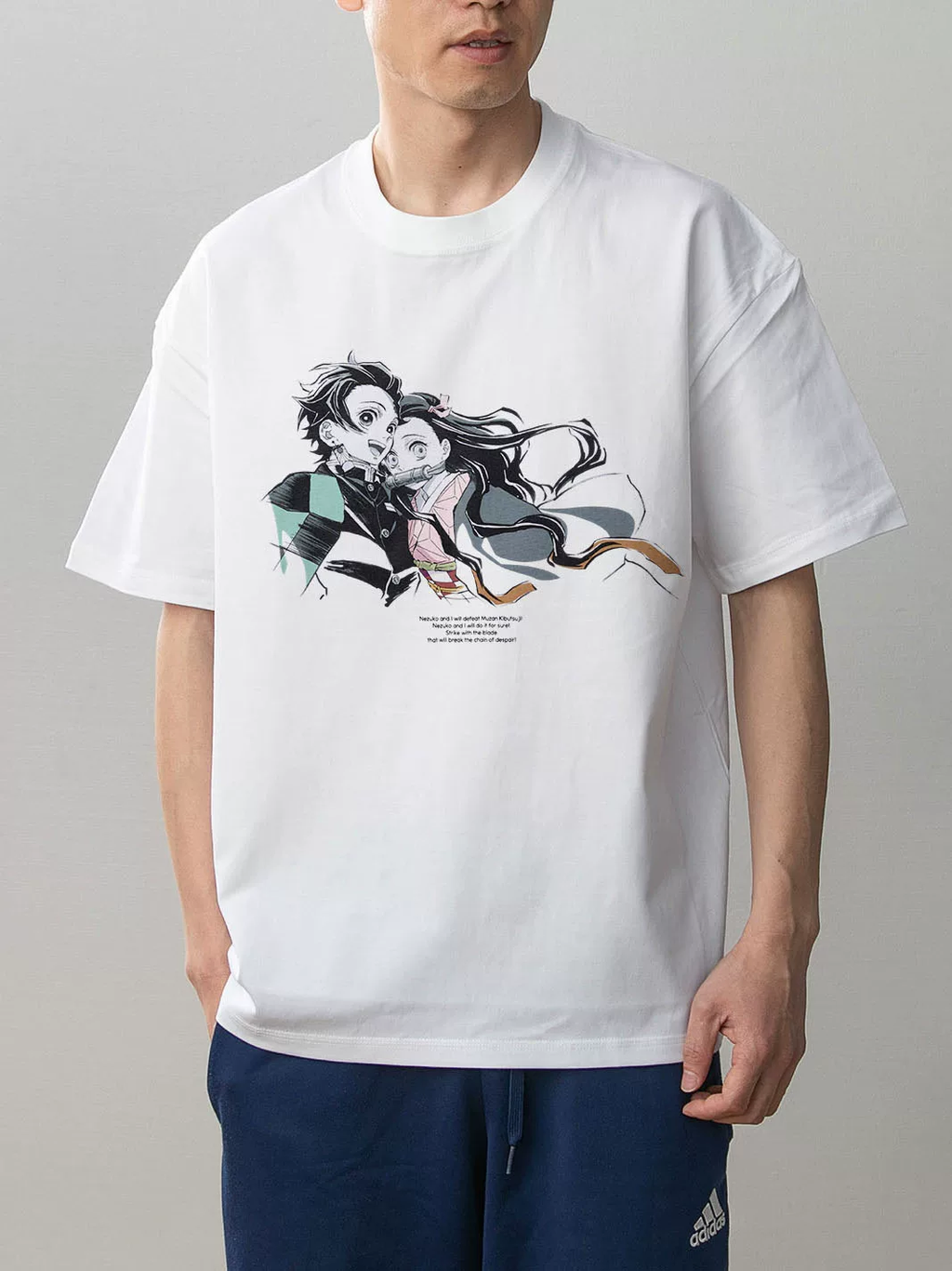Model wearing Moodixa white Demon Slayer Tanjiro and Nezuko graphic T-shirt, front view