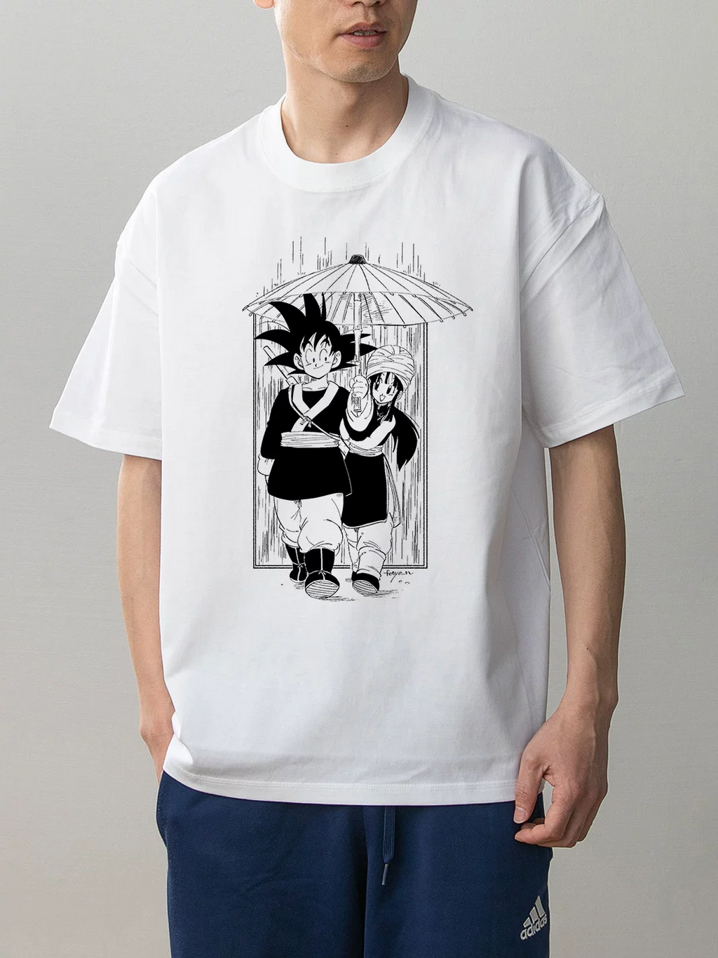 Dragon Ball Goku and Chi-Chi white cotton anime T-shirt on model front with monochrome umbrella manga illustration