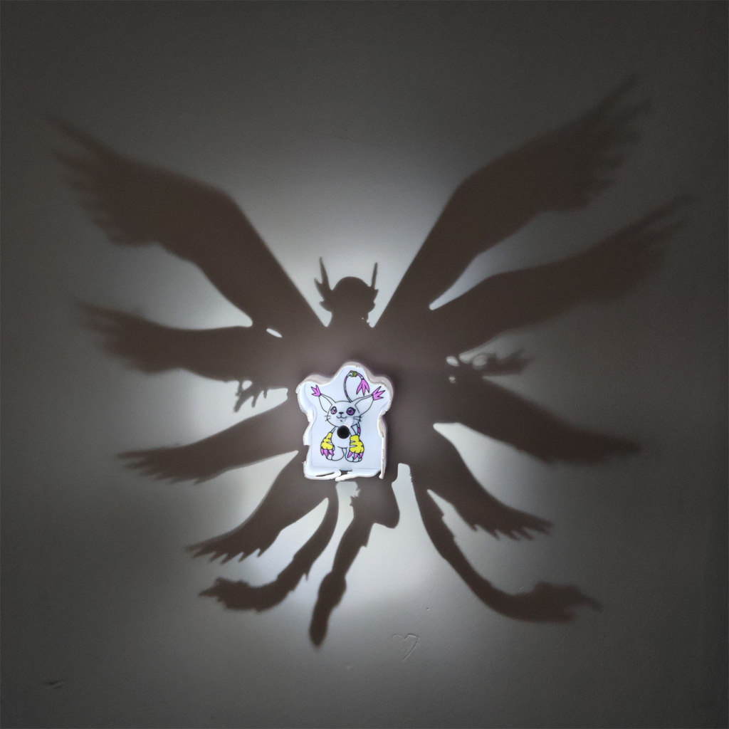 Gatomon-inspired Digimon shadow lamp illuminated on wall and casting a large mult-winged anime silhouette