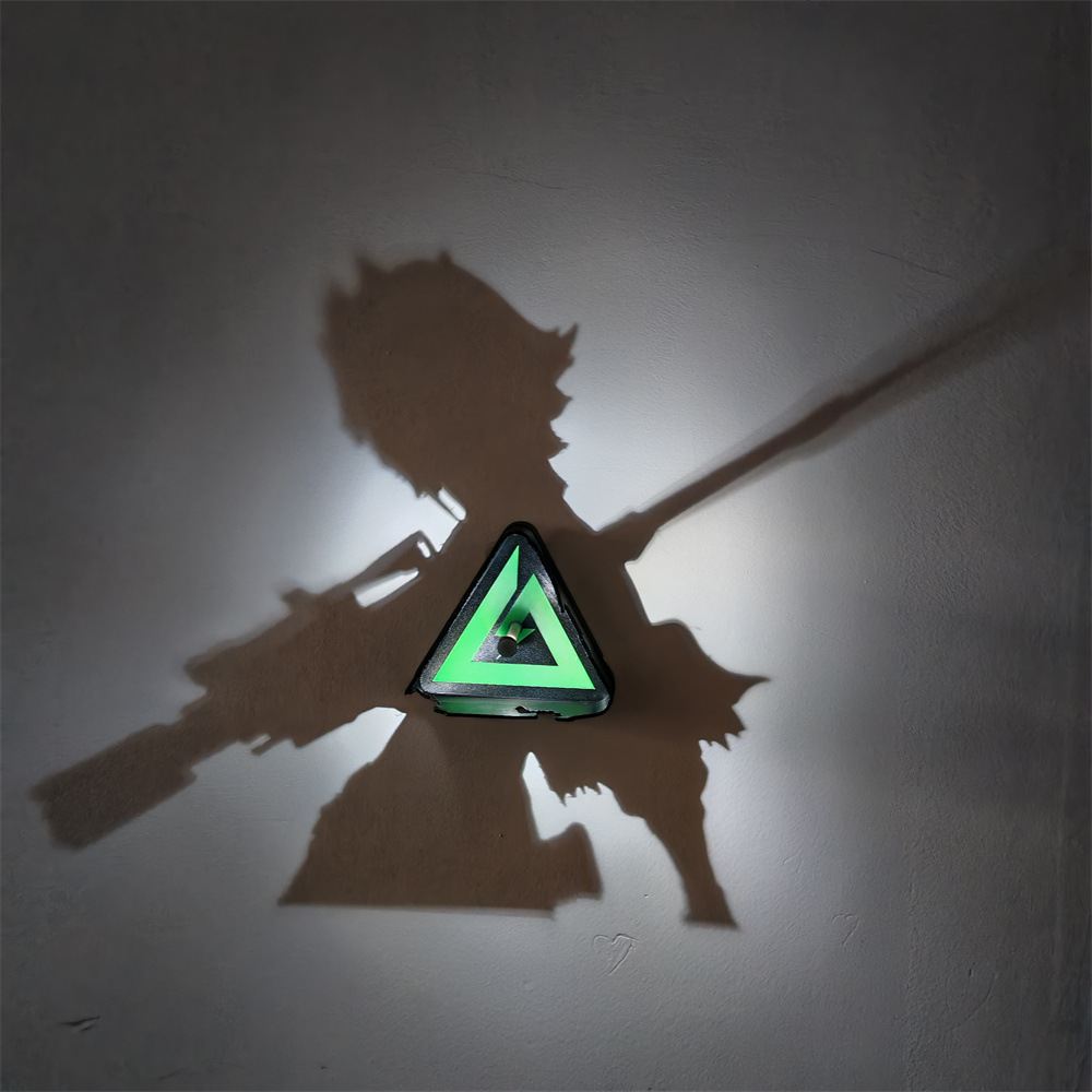 Warrior anime shadow projection lamp creating a large two-weapon fighter silhouette on a wall with a glowing green geometric triangle at its center