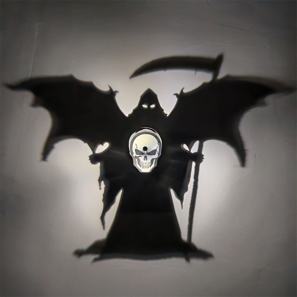 Grim Reaper Skull Shadow Lamp casting a large winged hooded reaper holding a scythe on a wall