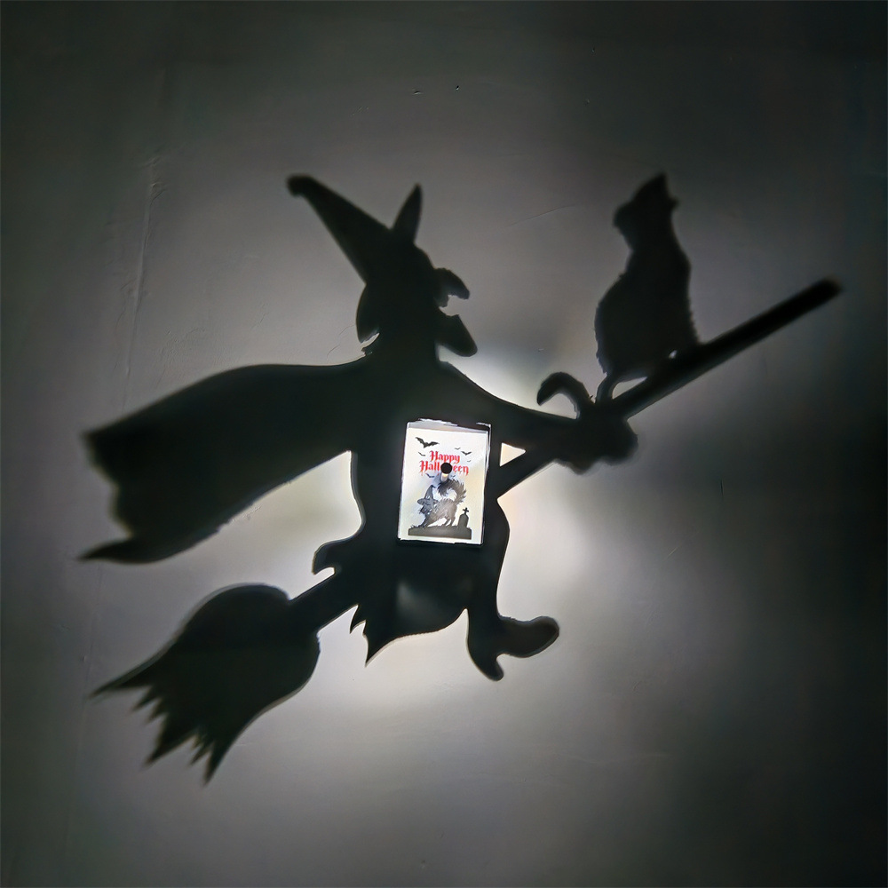 Halloween witch and black cat shadow lamp projecting a witch flying on a broomstick with a cat silhouette on the wall