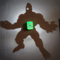 Hulk-inspired shadow projection lamp casting a large powerful superhero silhouette on a wall with an illuminated green fist emblem at its center