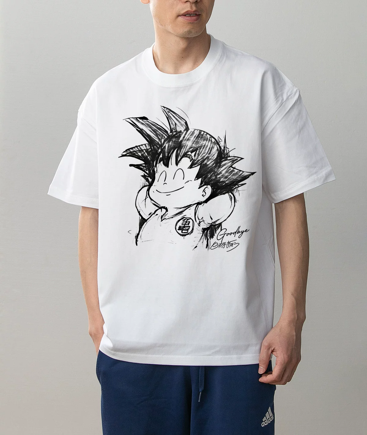 Kid Goku Goodbye smiling design white T-shirt worn on model, front view