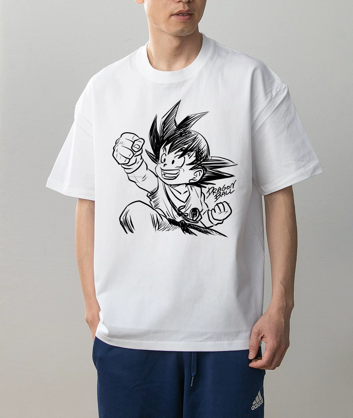 Kid Goku Punching action design white T-shirt worn on model, front view