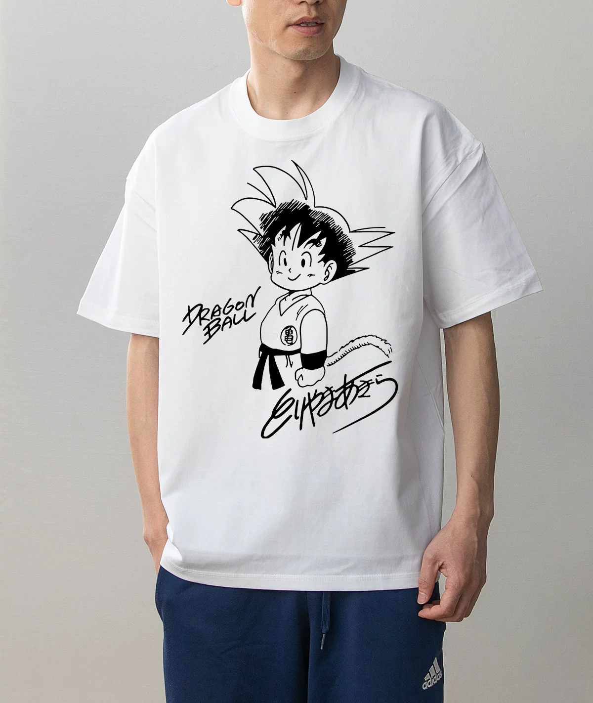 Kid Goku Standing classic design white T-shirt worn on model, front view