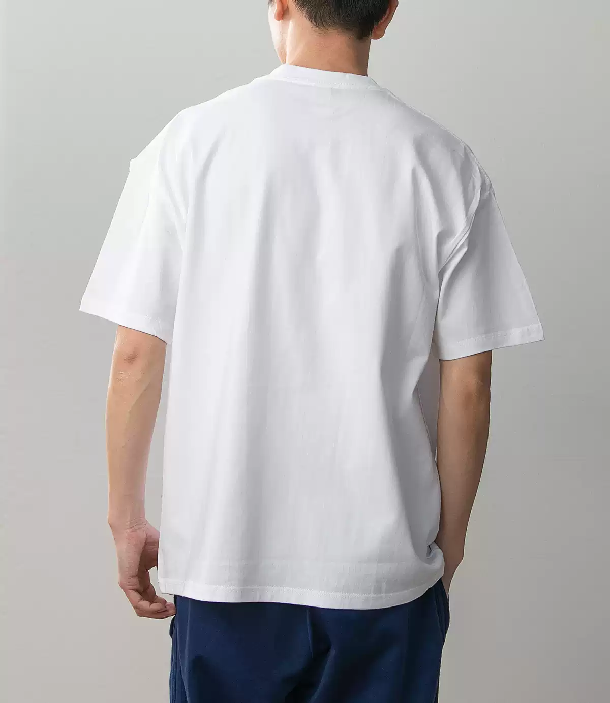 Kid Goku Dragon Ball white cotton T-shirt on model, plain back view