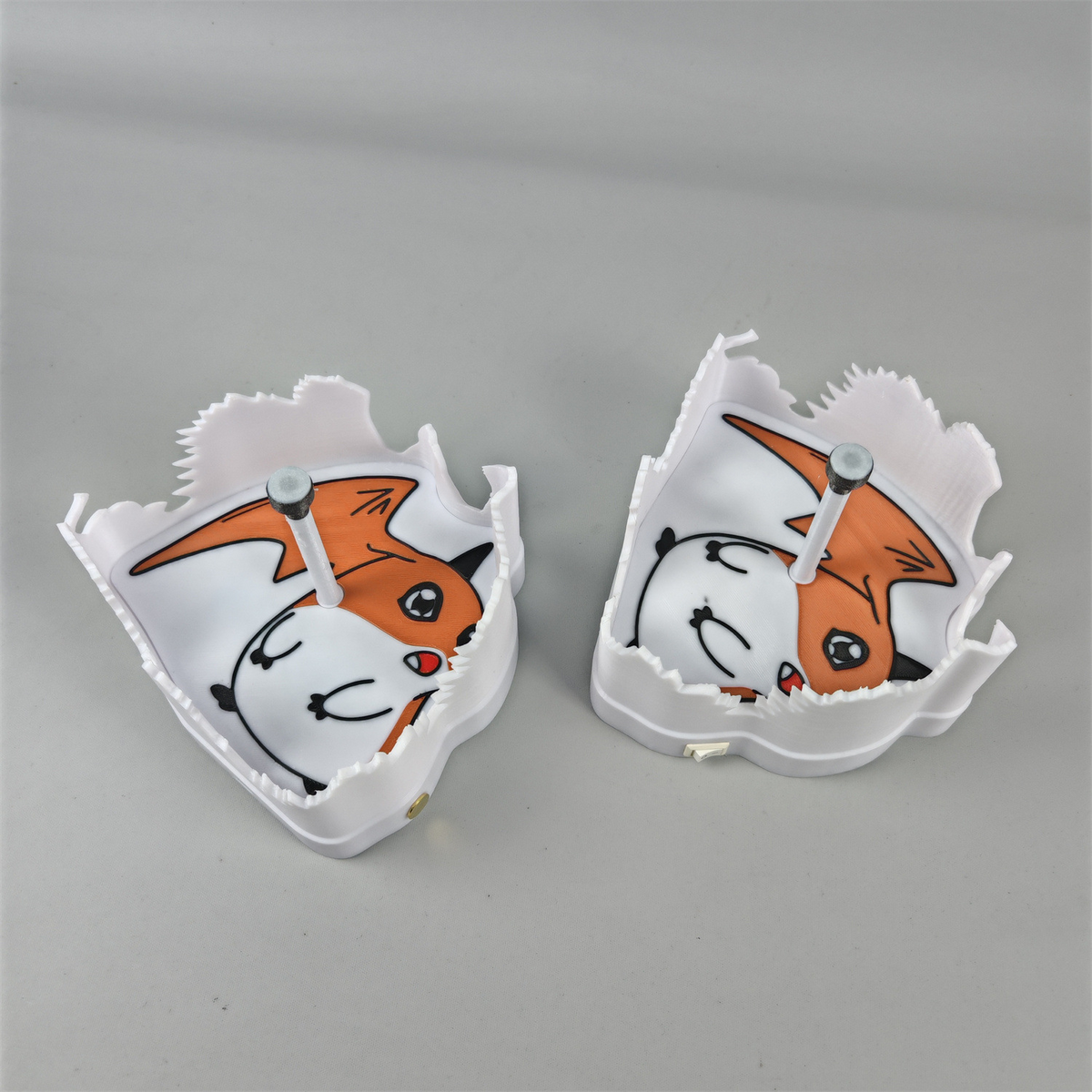 Back detail of orange and white Patamon-inspired shadow lamp with sculpted shape and rear projection supports