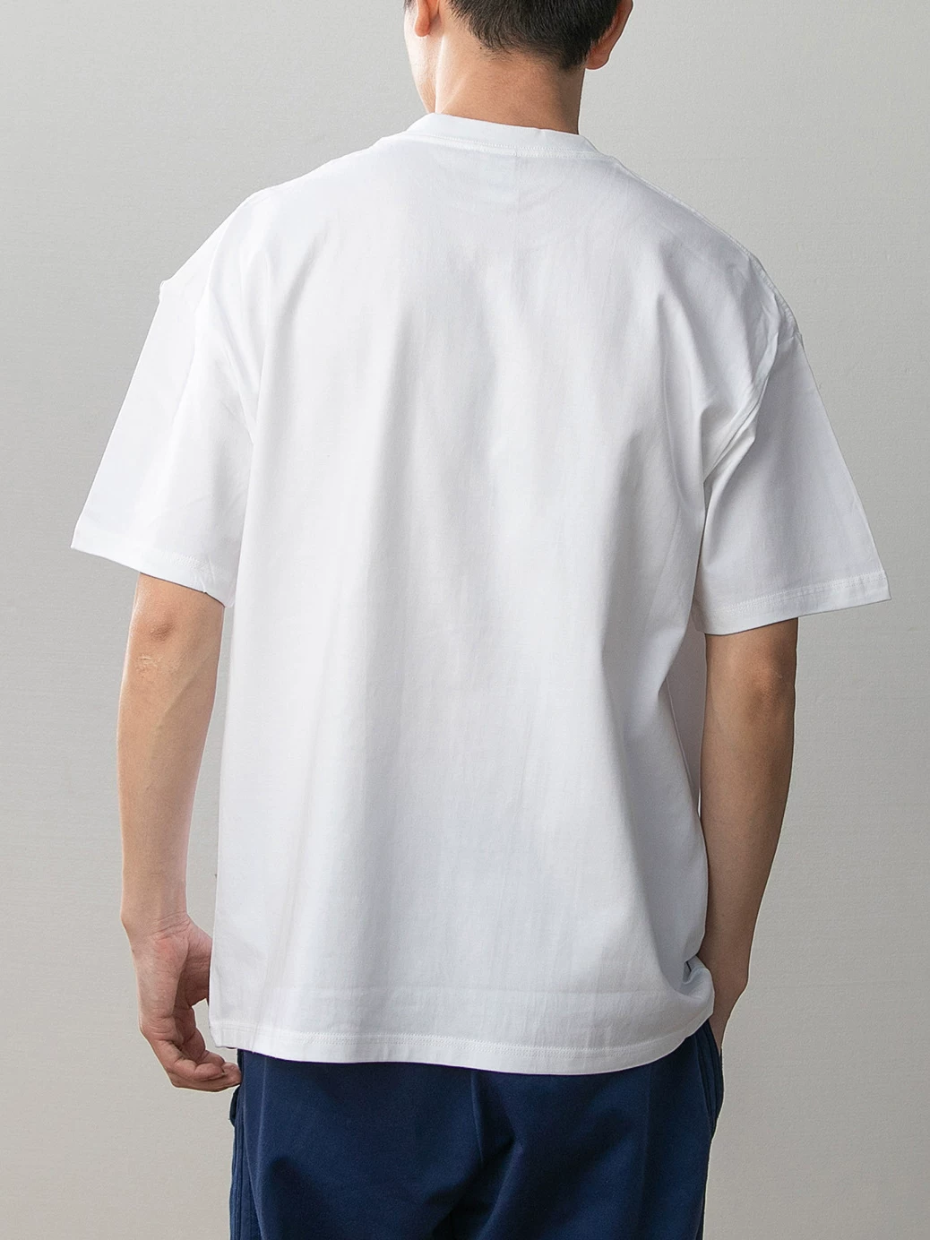 Pokémon Red Version white cotton graphic T-shirt model back showing plain white fabric