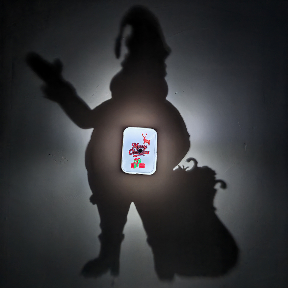 Santa Claus Christmas Shadow Lamp creating large Santa with sack wall silhouette and glowing Merry Christmas reindeer and gifts panel